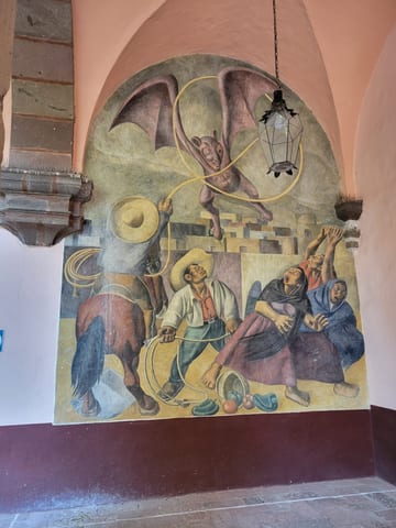 Traditional-style mural painted in an arched hallway